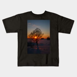 Sunset winter landscape with snow-covered road in violet and pink colors Kids T-Shirt